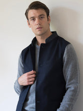 Nehru Gilet Made in England from Navy British Lambswool and a contrast Nehru collar in navy herringbone tweed. Known as Nehru Vest, Nehru Waistcoat, Nehru Gilet. Finished with horn buttons. British designer, British menswear, Made in England. Smart casual Menswear.